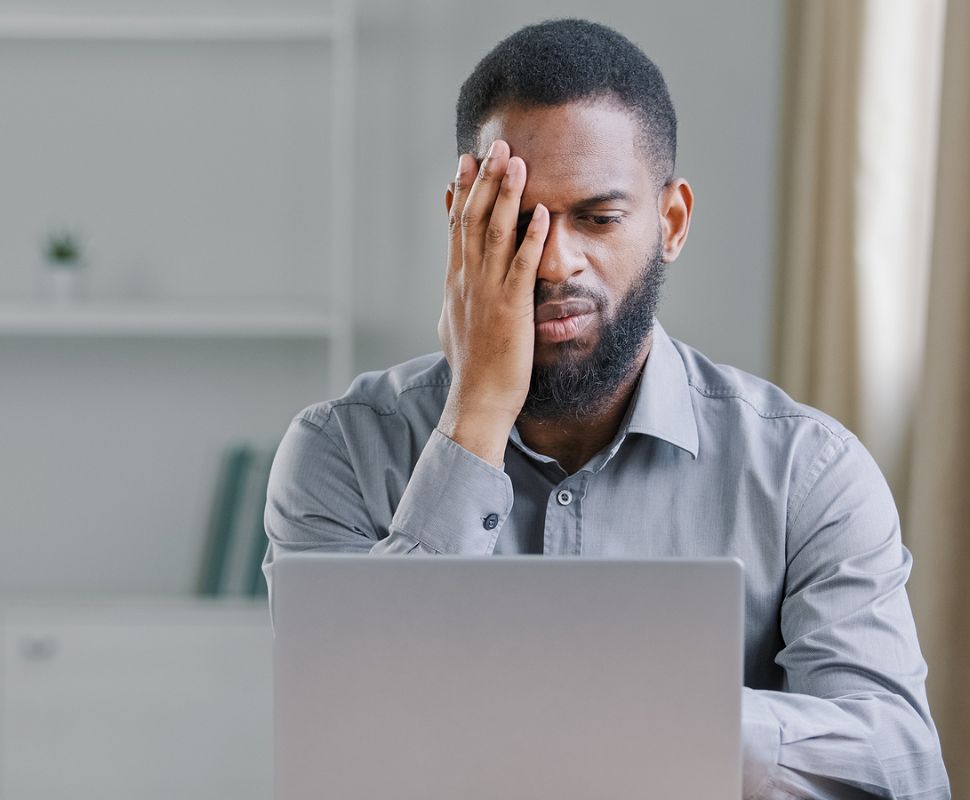 Counterfeit Berkey Products & Elements. A Black man is dismayed in front of his laptop.