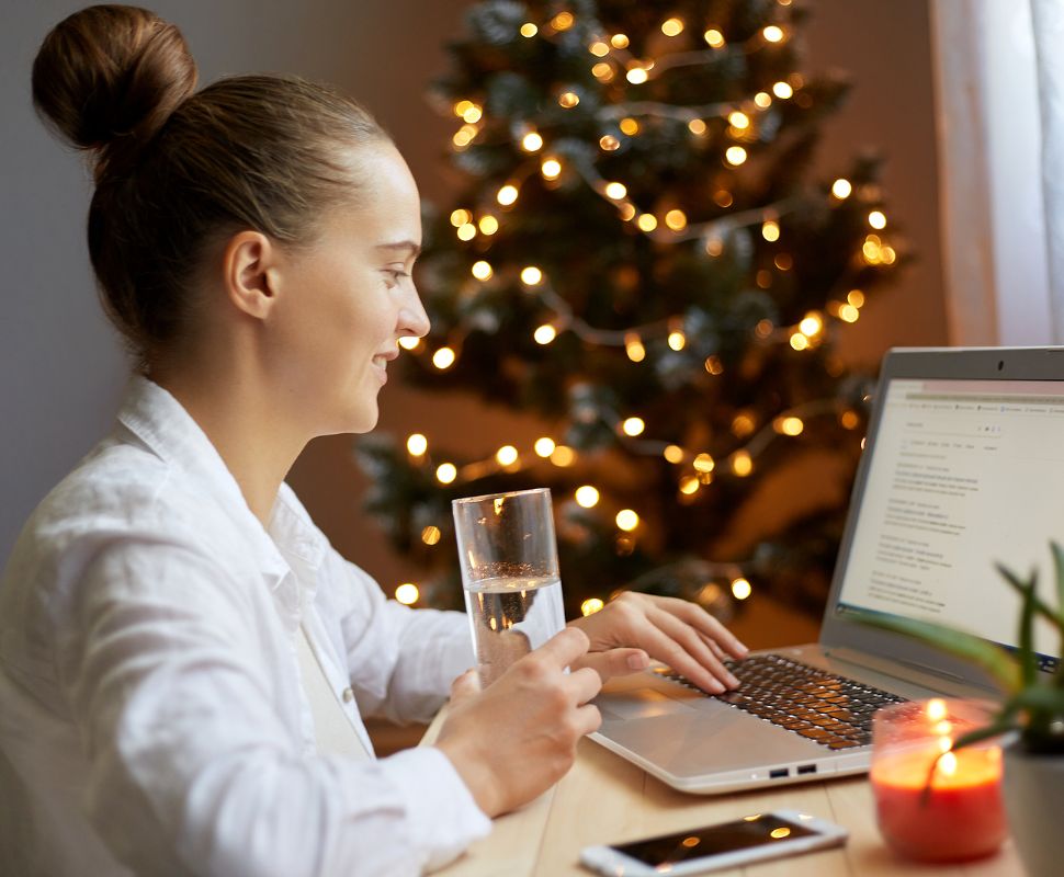 Someone enjoys a glass of water while online gift shopping