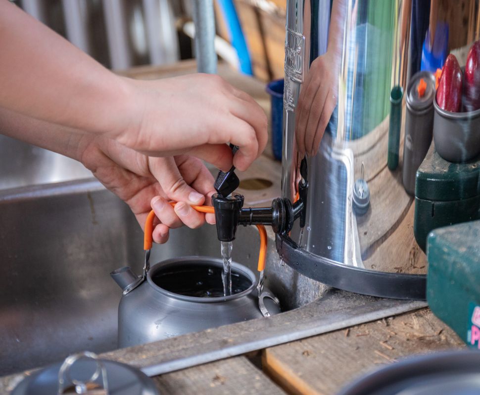 The Environmental Impact Of Using A Water Filtration System Someone filling a tea kettle with filtered water from their Berkey Water Filter.