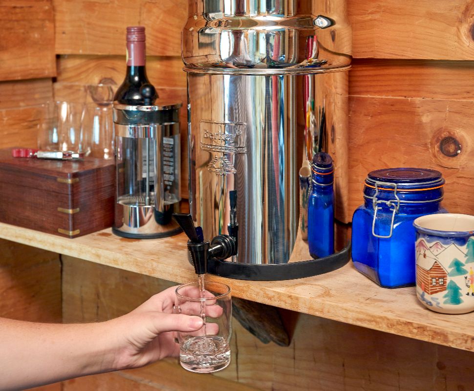 Someone pouring themselves water from their Berkey water filter